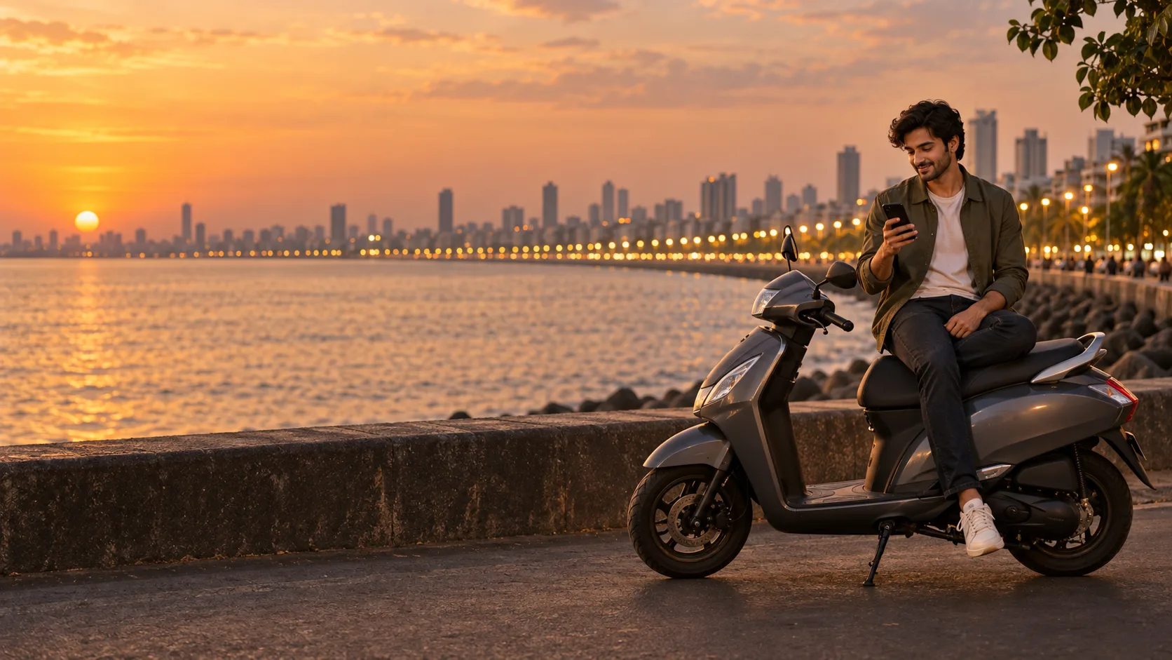 A rider reading on a phone beside a scooter on Marine Drive